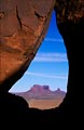 Looking through a small teardrop shaped arch near Monument Valley, Arizona.