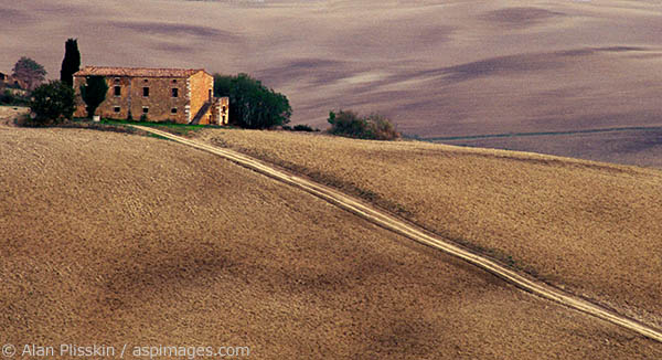 This old Tuscan farm sits on a ridge surrounded by plowed fields