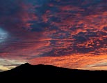 Mt Tamalpias is silhouetted against a colorful evening sky.