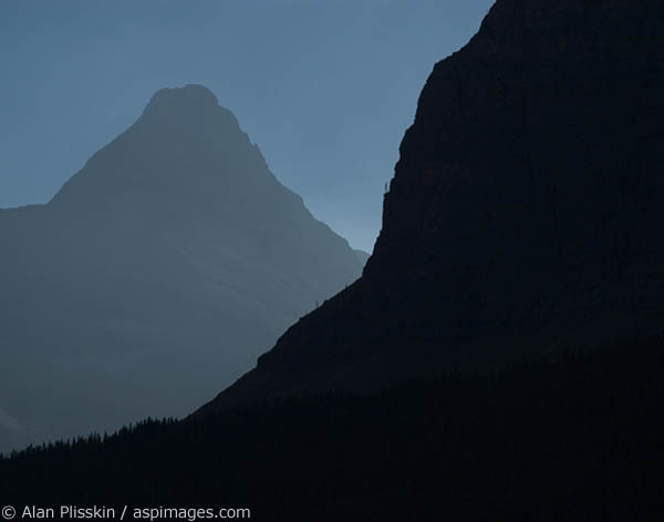 Mountains in Glacier National Park are silhouetted in the morning sun
