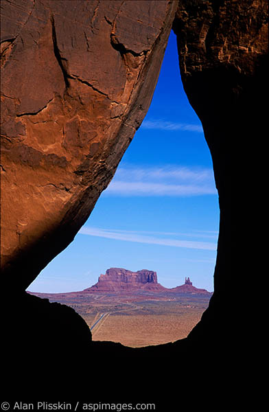 Looking through a small teardrop shaped arch near Monument Valley, Arizona.